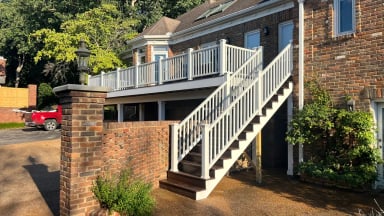 Staircase leading to a modern house with a deck.