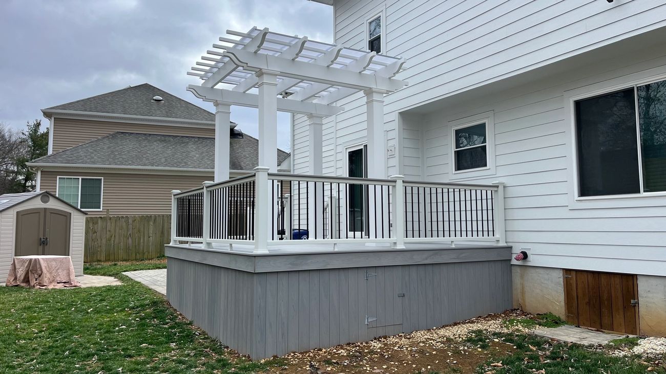 White wooden deck and pergola in backyard
