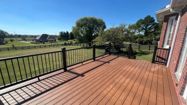 Scenic view of a wooden deck overlooking a green field.