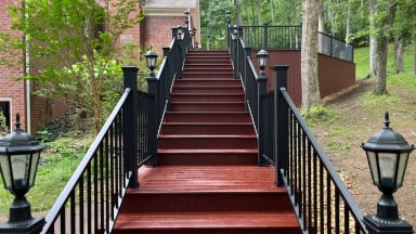 wooden staircase with decorative black railings