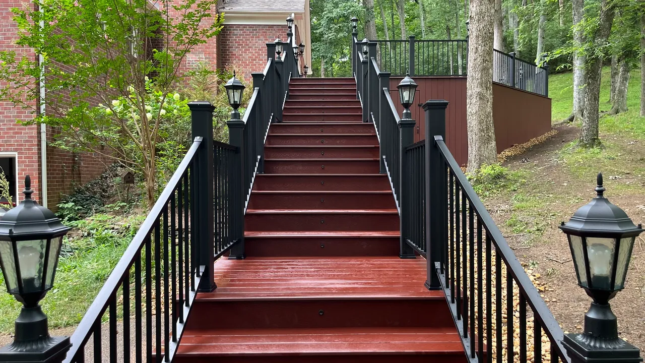 wooden staircase with decorative black railings
