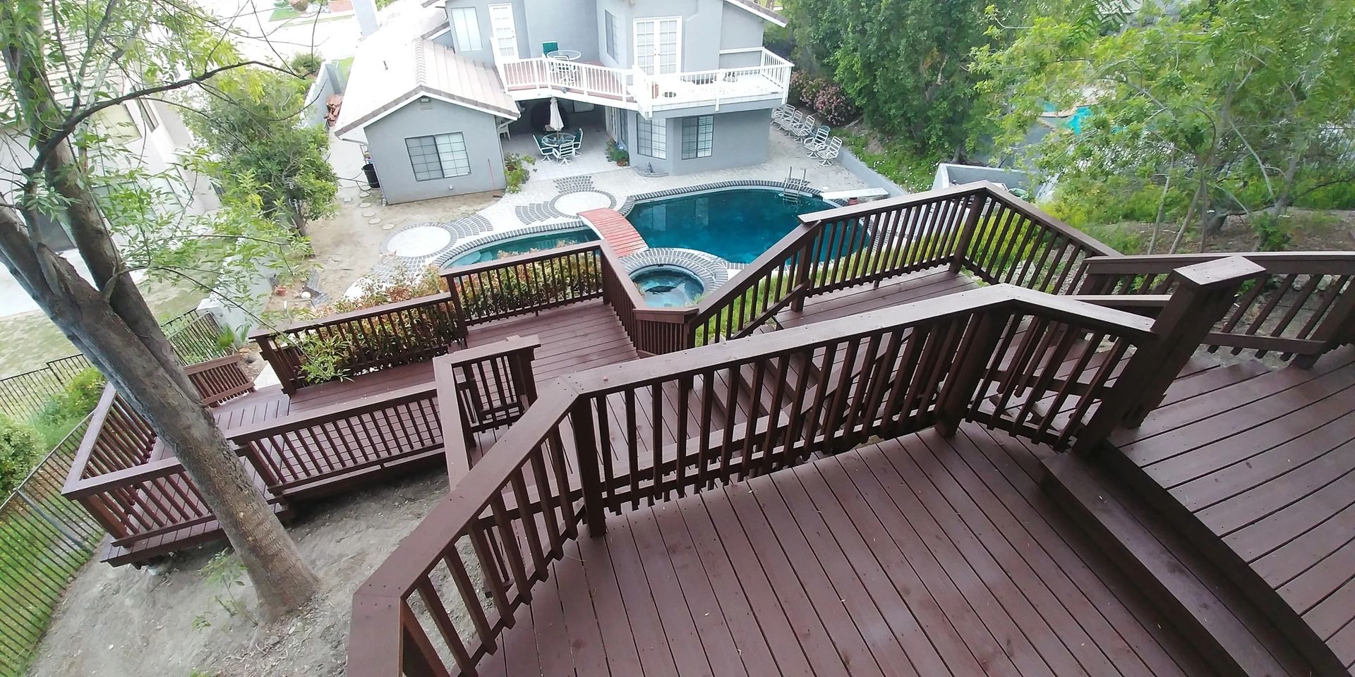 Wooden stairway leading to a pool area.
